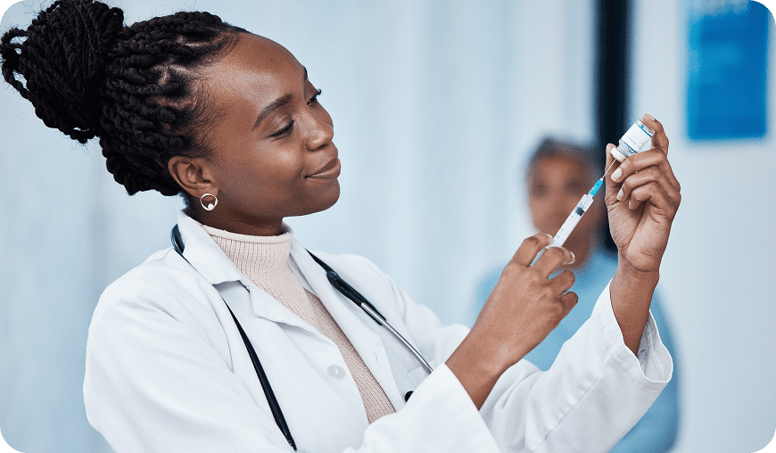 Doctor preparing a syringe for injection.